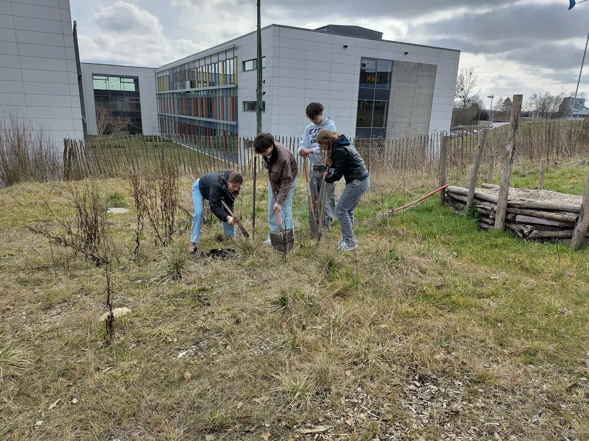 Young people working together in the garden during an on-site workshop